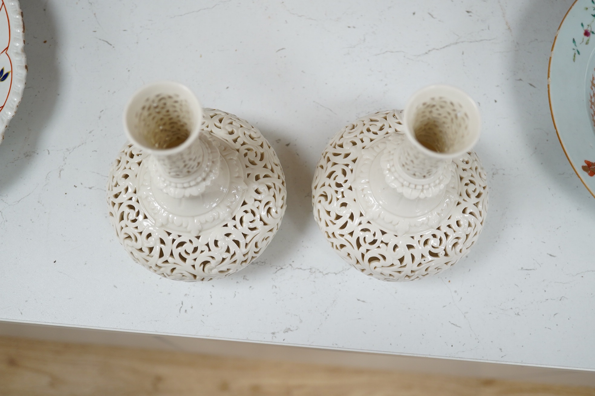 A pair of unsigned Worcester style reticulated vases, 18cm high. Condition - one repaired at neck